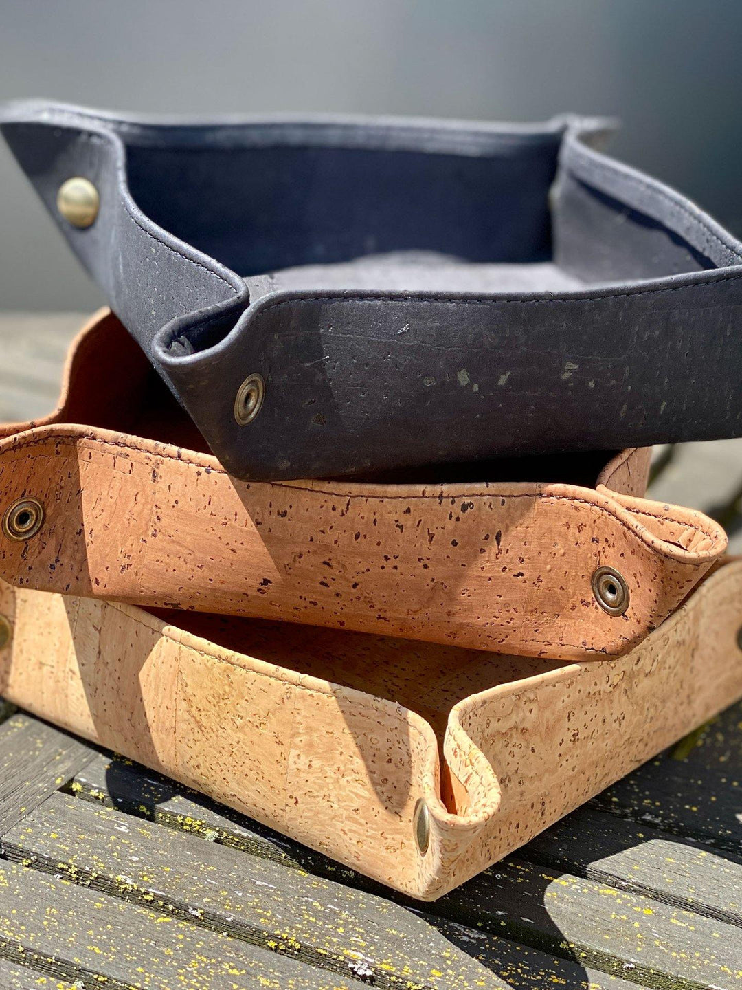 Rectangular cork catch-all tray for organizing small items on a surface.