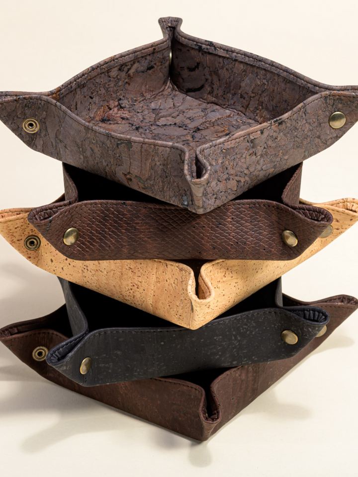 Cork catch-all tray for organizing keys and small items on a clean surface.