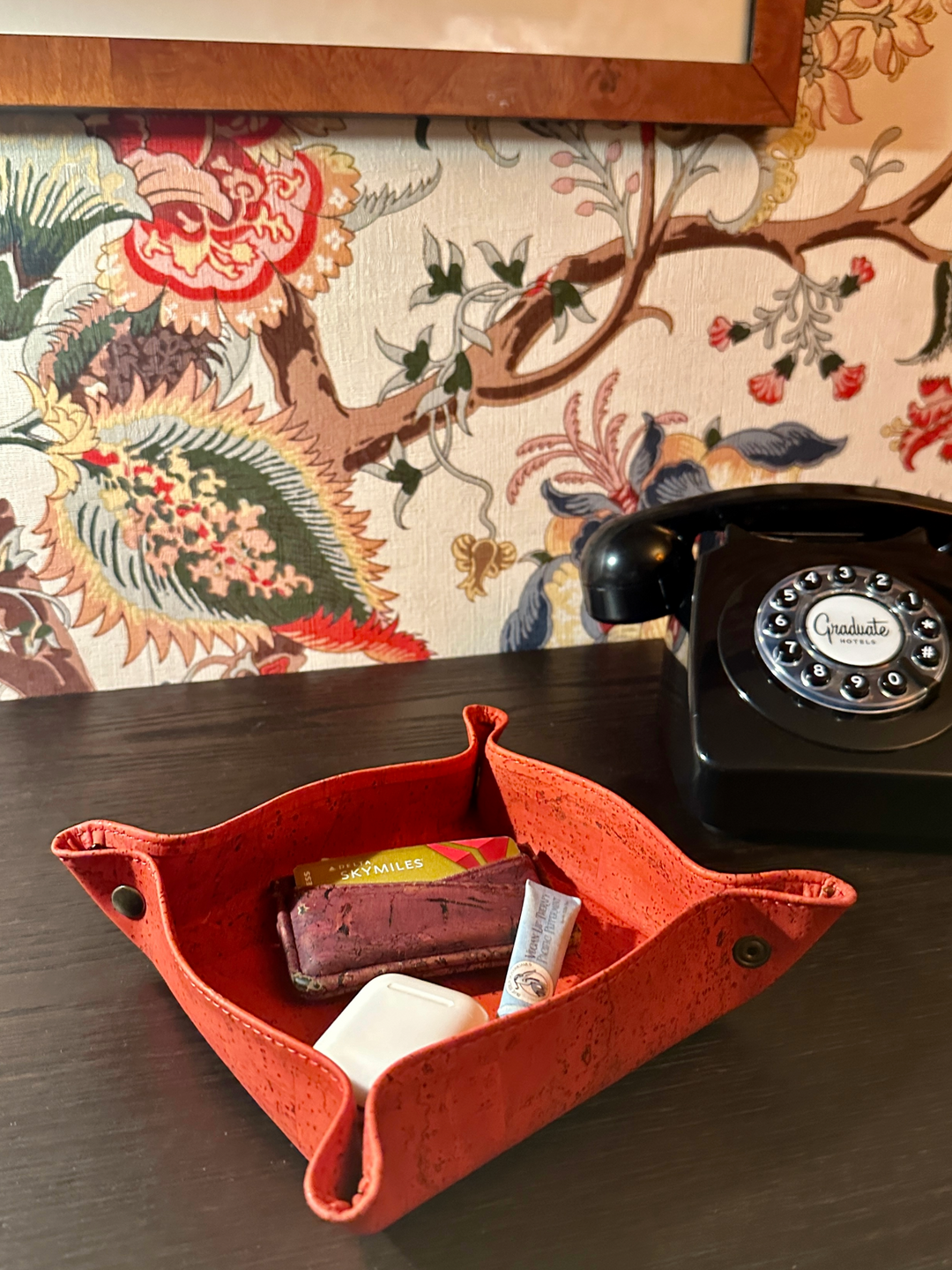 Rectangular cork catch-all tray with raised edges for organizing small items.