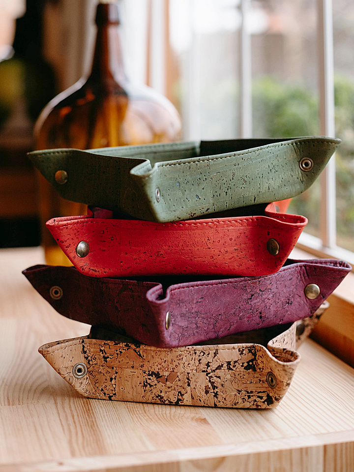 Cork catch-all tray with raised edges for keys, coins, and small items on a tabletop.