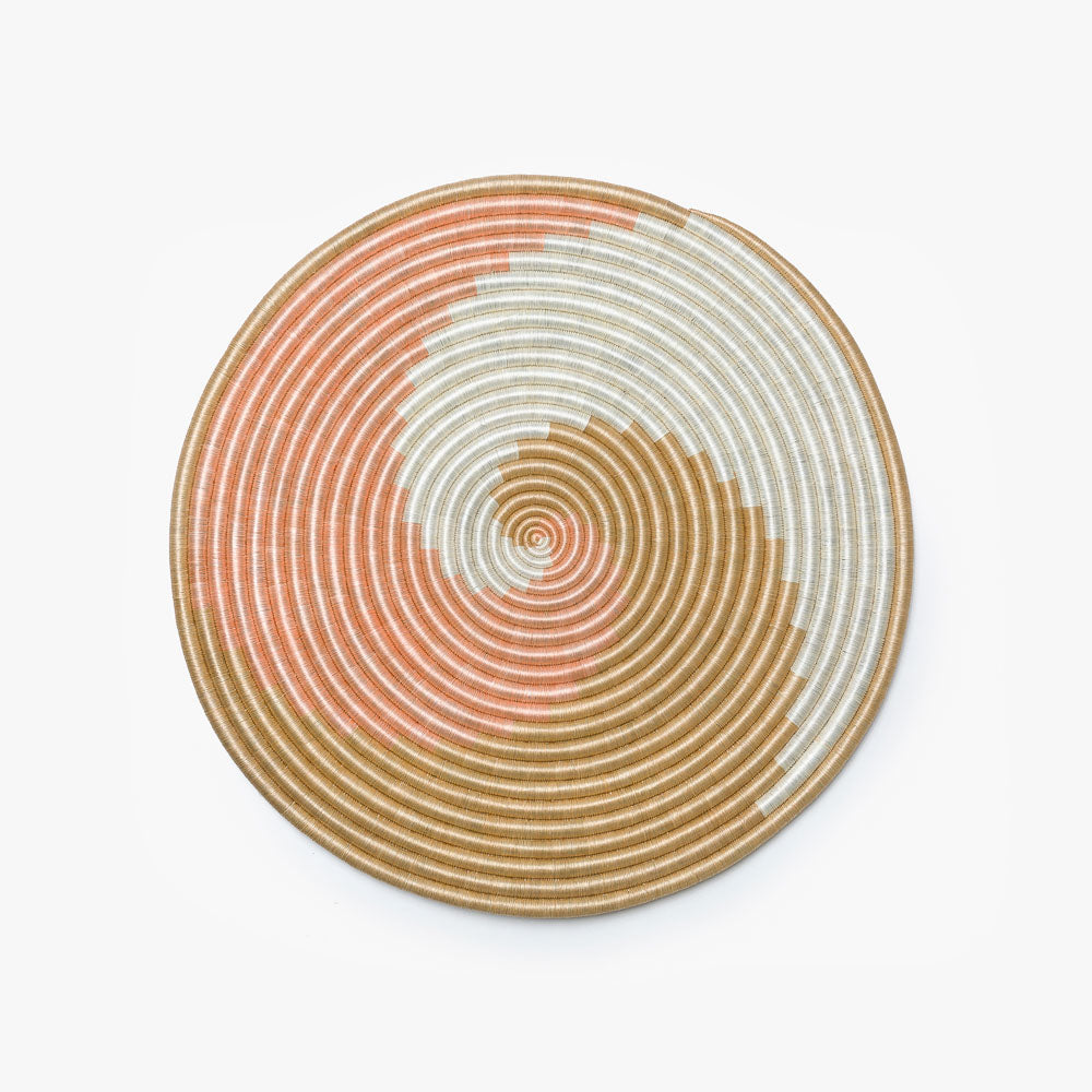 Large blush, white, and tea flat woven sisal wall hanging, shown overhead.