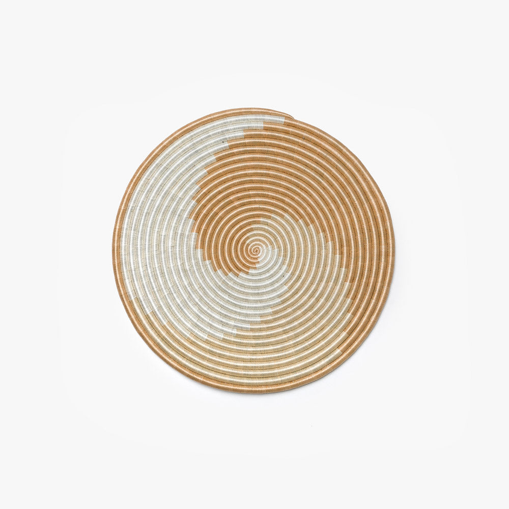 Medium white and tea flat woven sisal wall hanging shown on a wall.