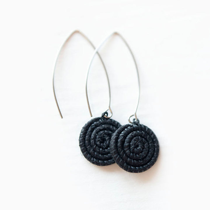 Black and white hand-woven sisal earrings with a zigzag pattern.