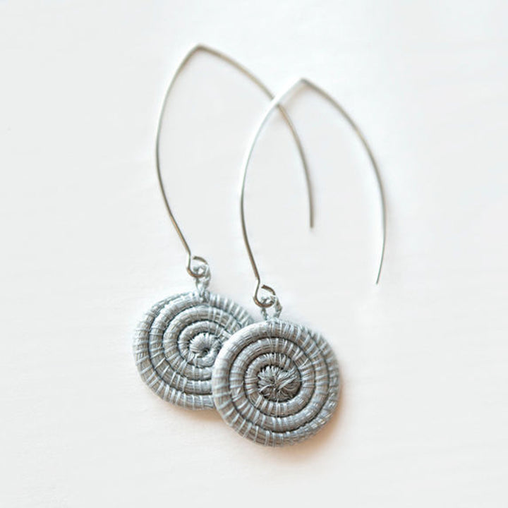 Ice blue hand-woven sisal earrings with intricate woven patterns.
