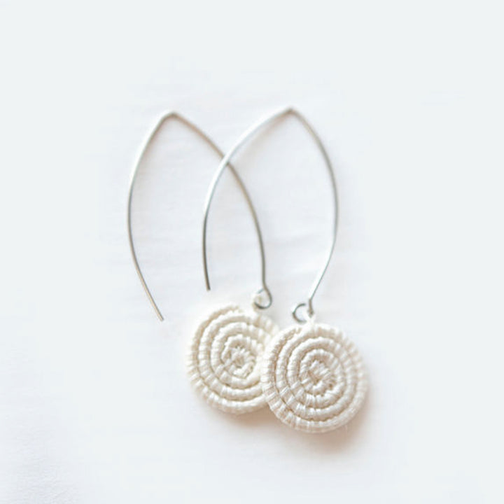 White hand-woven sisal earrings with natural texture and intricate detail.