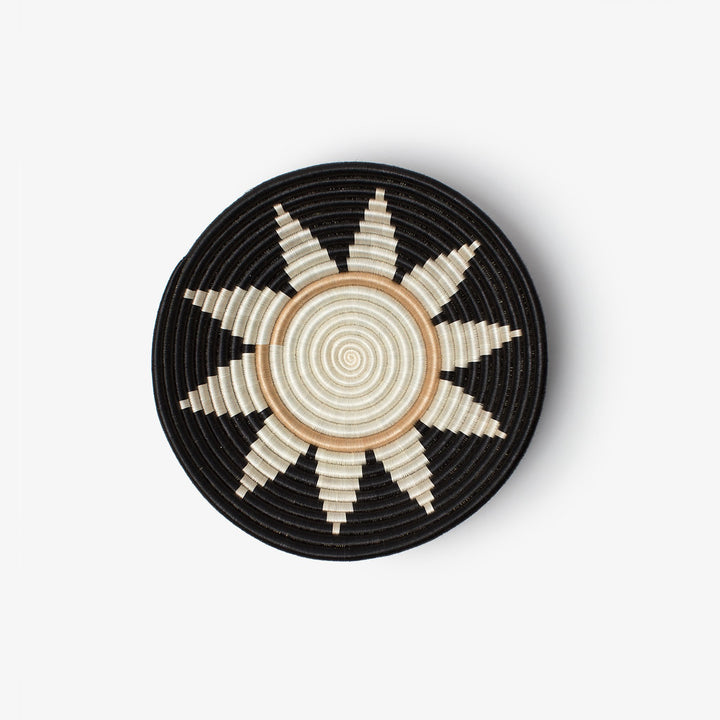 Medium Zuba woven bowl in black sisal with a white sunburst star and tan center ring.
