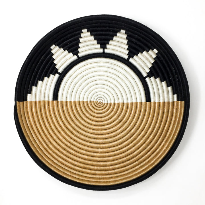 Overhead view of a Zubita woven bowl in black and natural sisal with a star-spiral pattern.