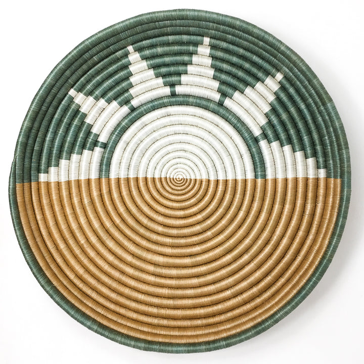 Overhead view of a teal Zubita woven bowl with white star-spiral patterning.