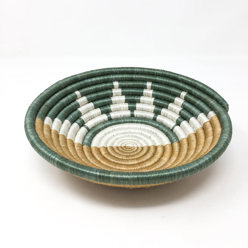 Zubita woven bowl with a teal and white interior and star-spiral pattern.