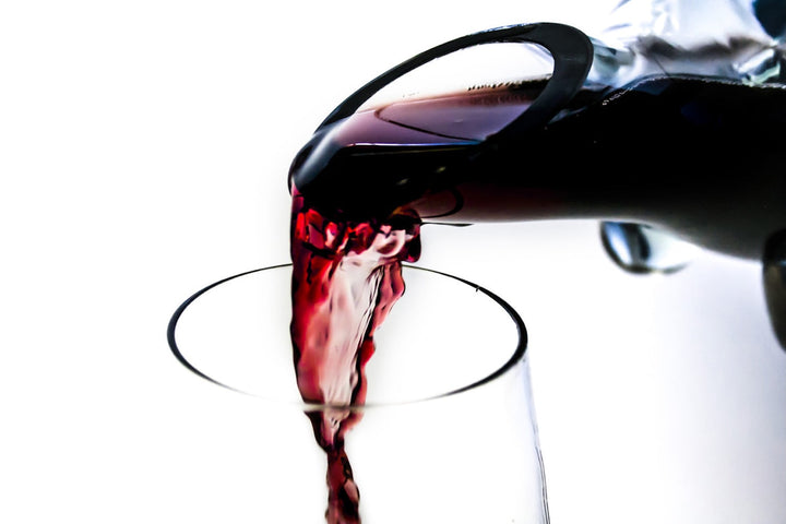 Recycled-glass horn wine decanter, hand-blown with a graceful curved horn-inspired form.