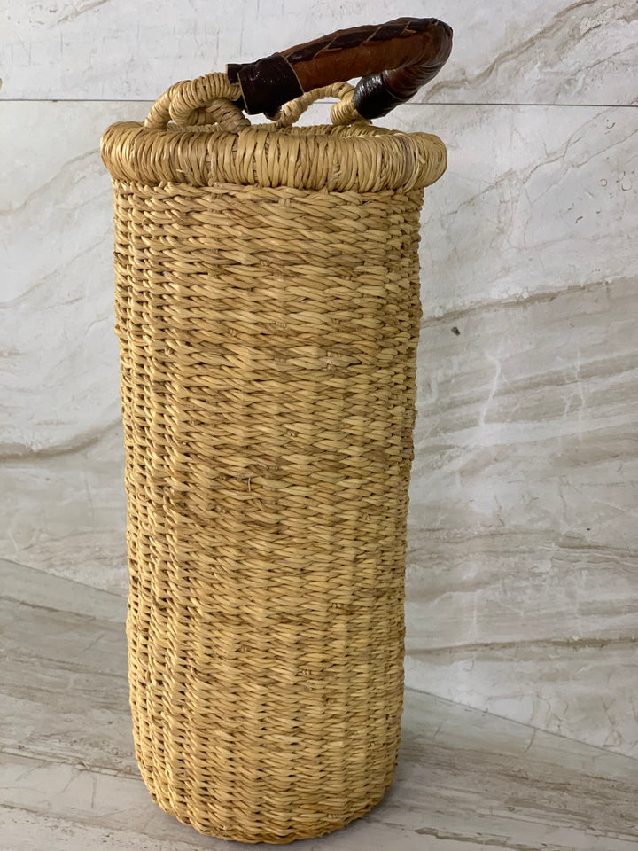 Handwoven straw Astoria vase and wine-bottle holder with a leather handle.