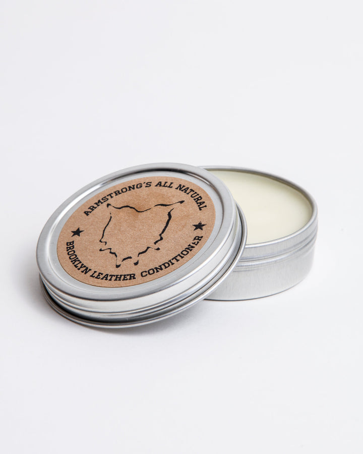 Brooklyn Leather Conditioner in a tin for nourishing and softening leather.