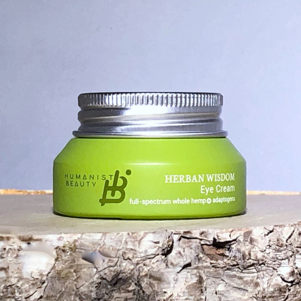 Herban Wisdom eye cream in a jar, showing its smooth, creamy texture.