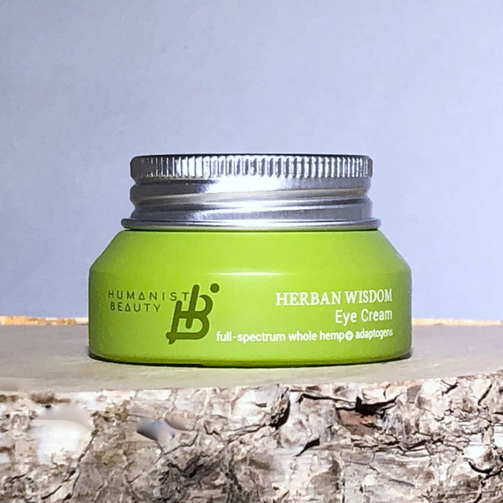Herban Wisdom eye cream in a jar, showing its smooth, creamy texture.