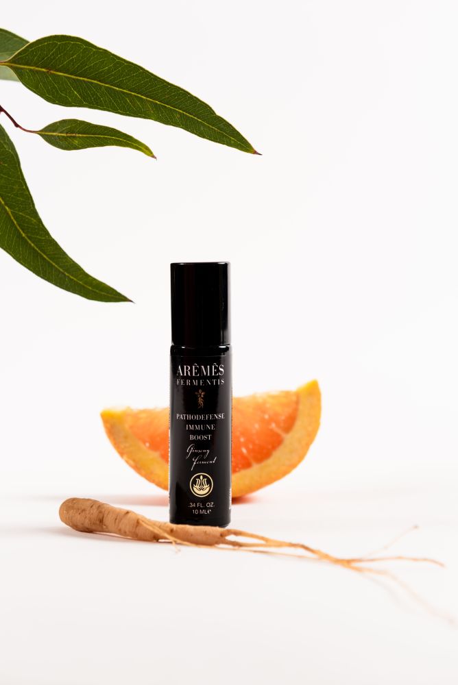 PathoDefense essential oil roll-on with a roll-on applicator.