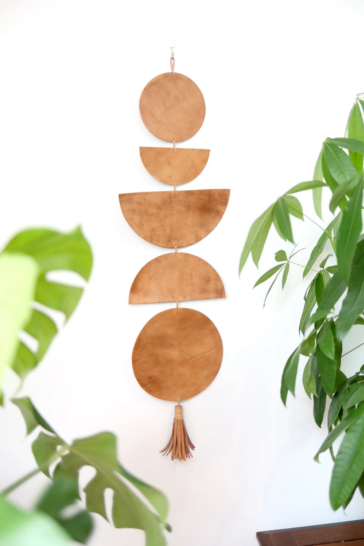 Large leather Luna moon-phase wall hanging with crescent and full moon shapes.