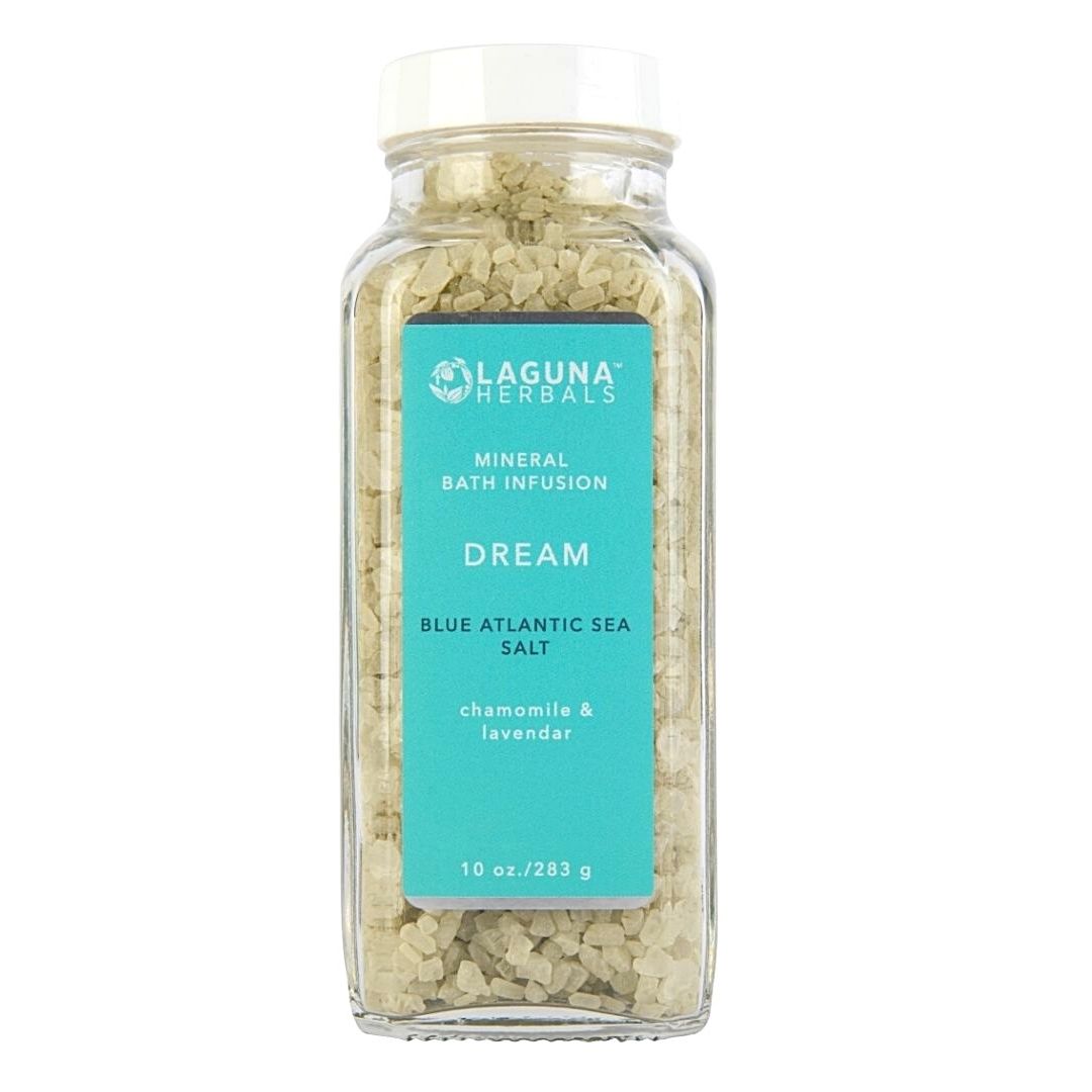 Dream mineral bath salt with lavender and chamomile in a clear jar, with lavender flowers.