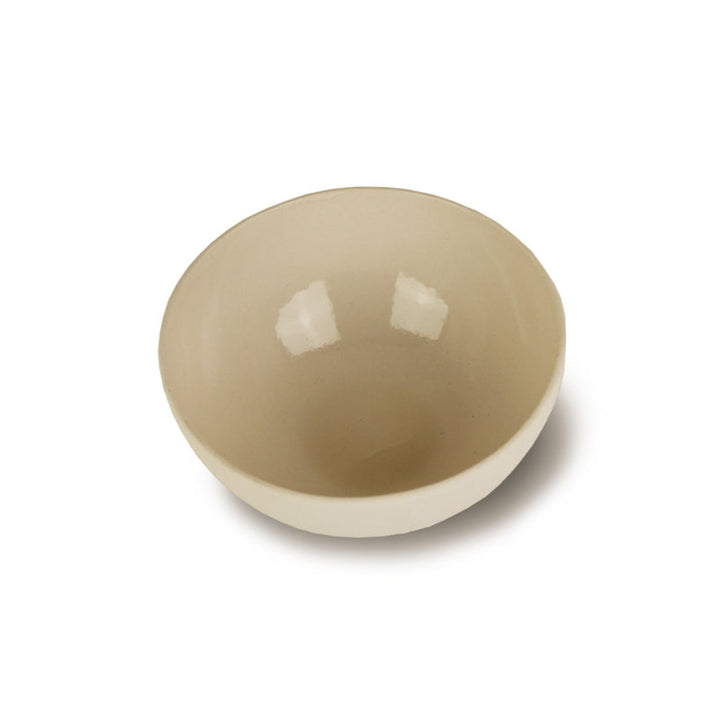 Handmade porcelain bowl in cream, smooth round shape.
