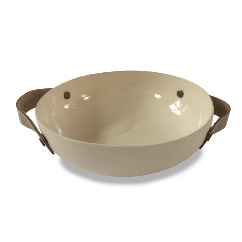 Handmade ceramic bowl with leather handles, showing its shape and textured surface.