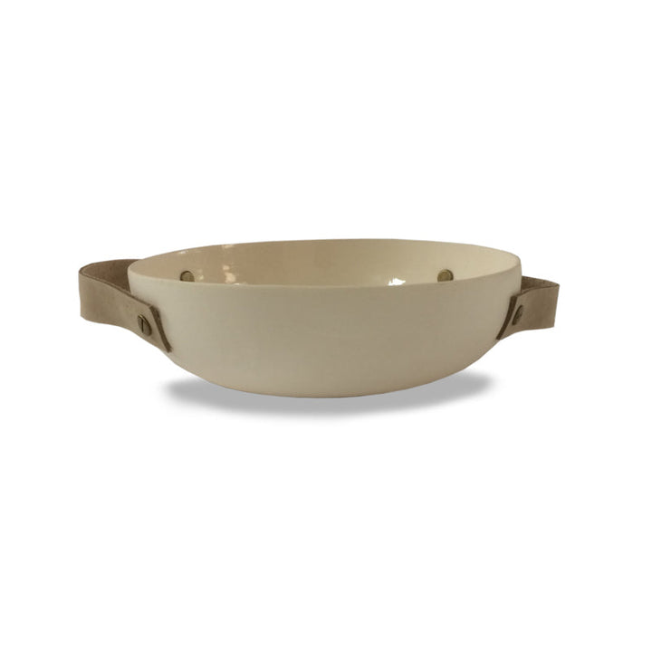 Handmade ceramic bowl with leather handles, glazed surface with leather accents.