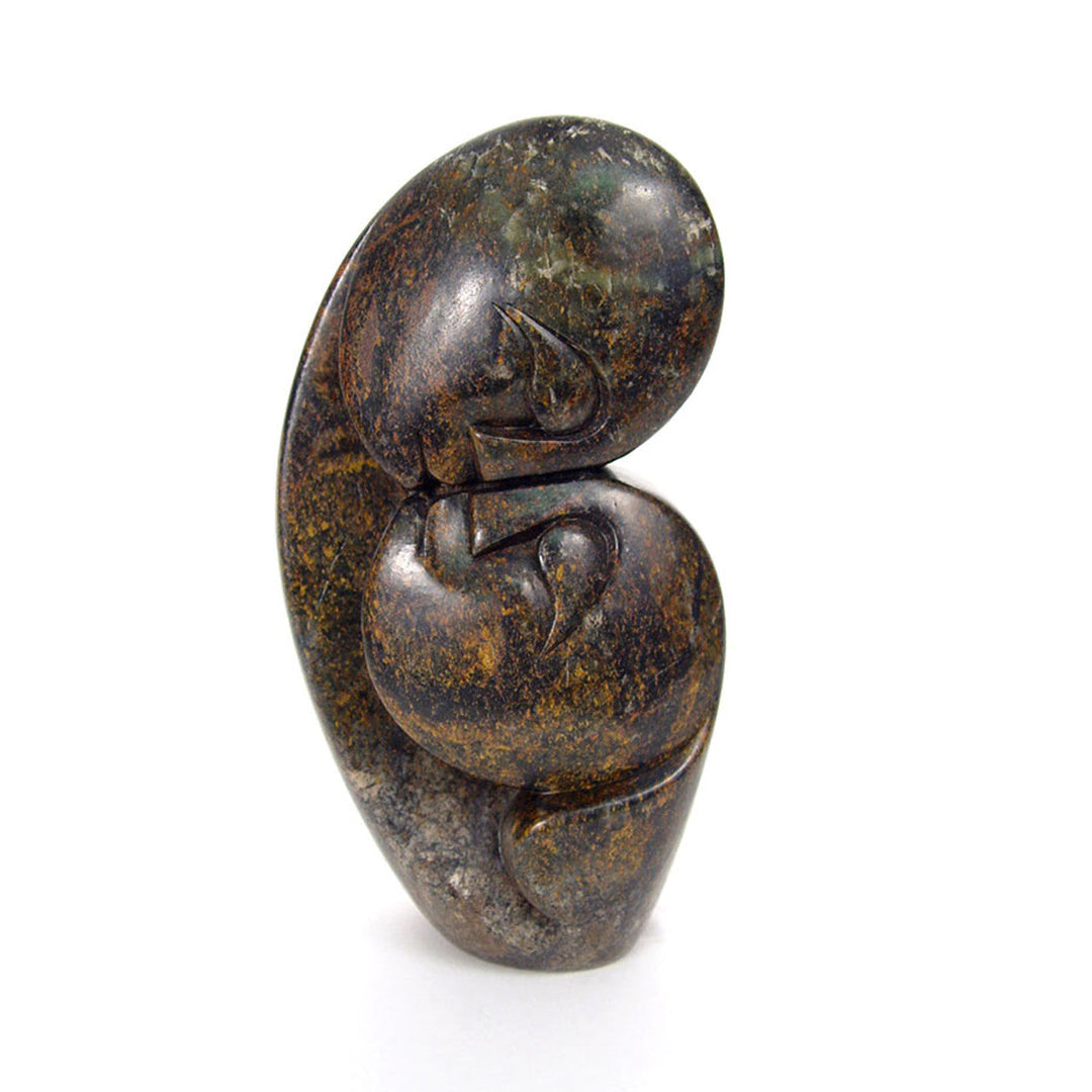Hand-carved Kissing Lovers serpentine stone sculpture of a couple embracing.