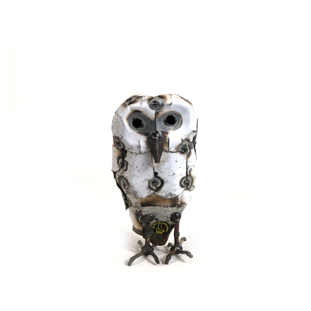 Recycled metal snowy owl sculpture with intricate hand-shaped feather detail.