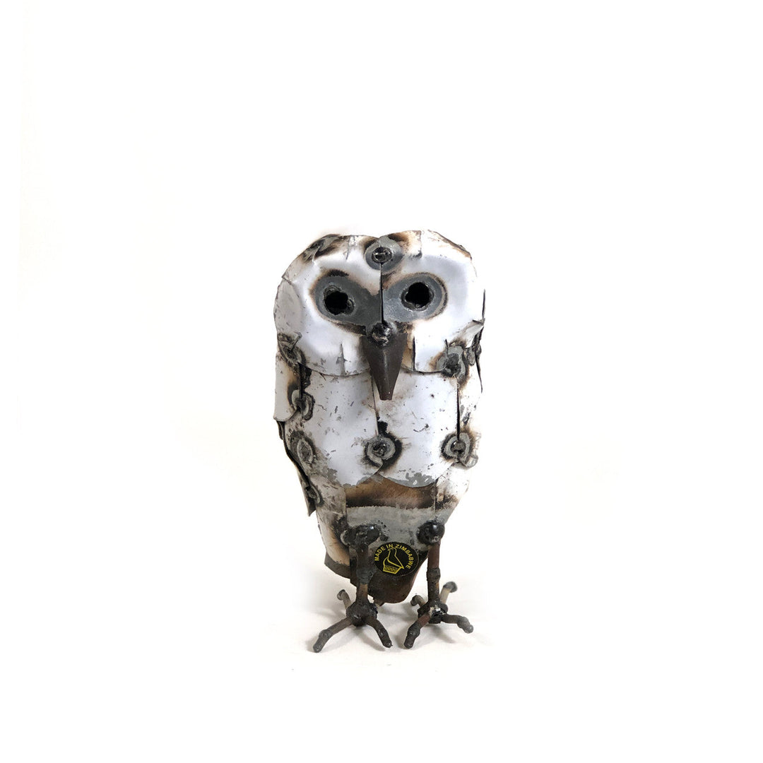 Recycled metal snowy owl sculpture with intricate hand-shaped feather detail.