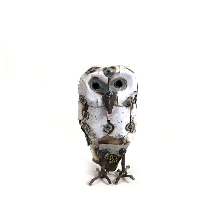 Recycled metal snowy owl sculpture with intricate hand-shaped feather detail.
