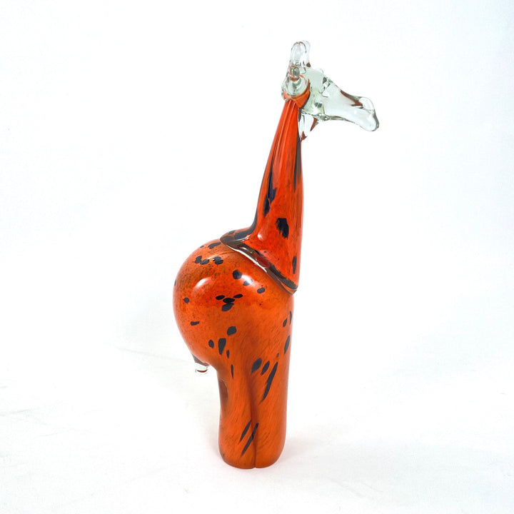 Detailed handblown orange glass giraffe catching the light.
