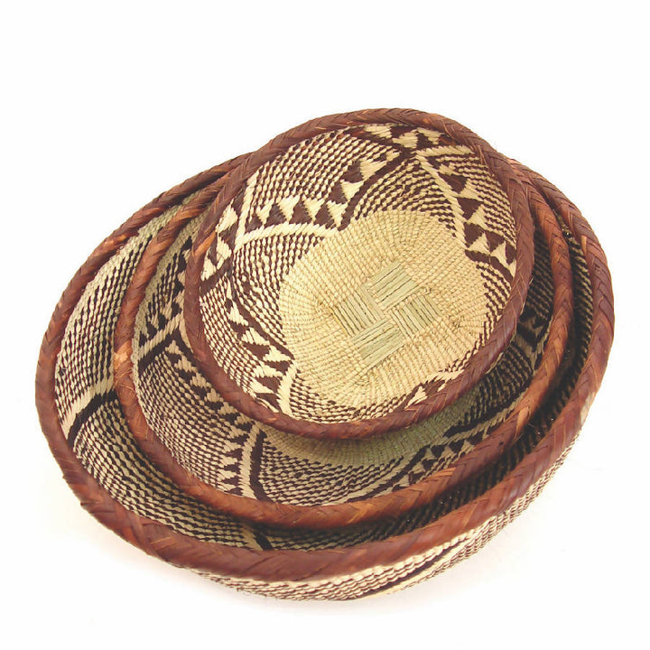 Handwoven Tonga basket bowls, rounded natural-fiber bowls with an intricate weave.