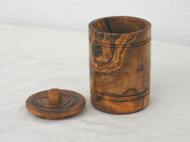 Hand-carved olive wood spice jar with lid, showcasing a smooth finish and natural wood grain.
