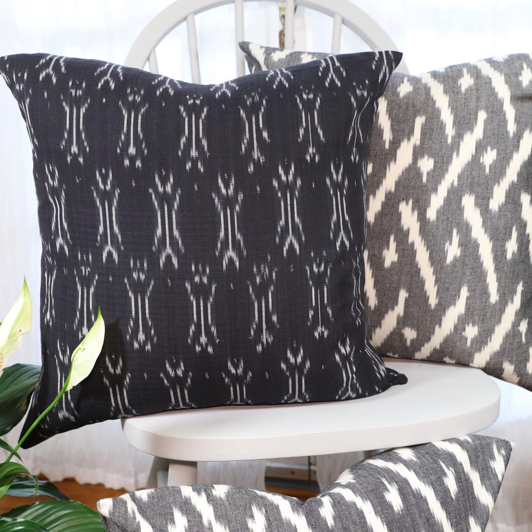 Handwoven black and white ikat cotton throw pillow cover, pattern detail.