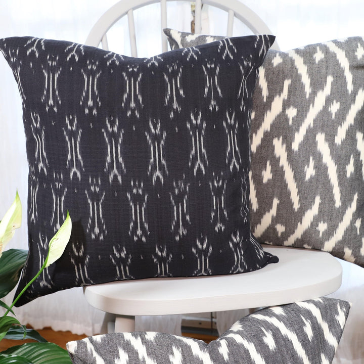 Handwoven black and white ikat cotton throw pillow cover, pattern detail.