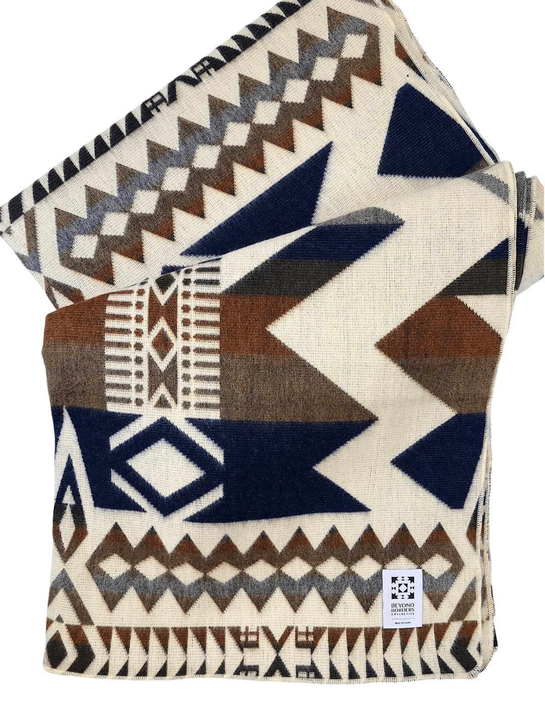 Awa Earth Andean throw blanket in navy, brown, and rust on a cream ground.