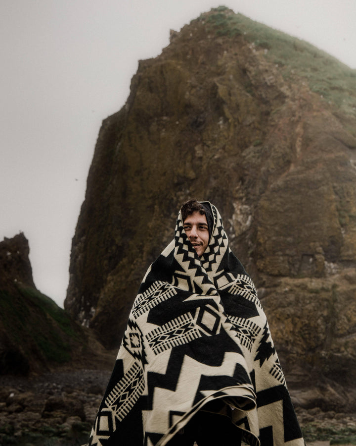 Handwoven Awa throw blanket in monochrome black on a natural cream ground.