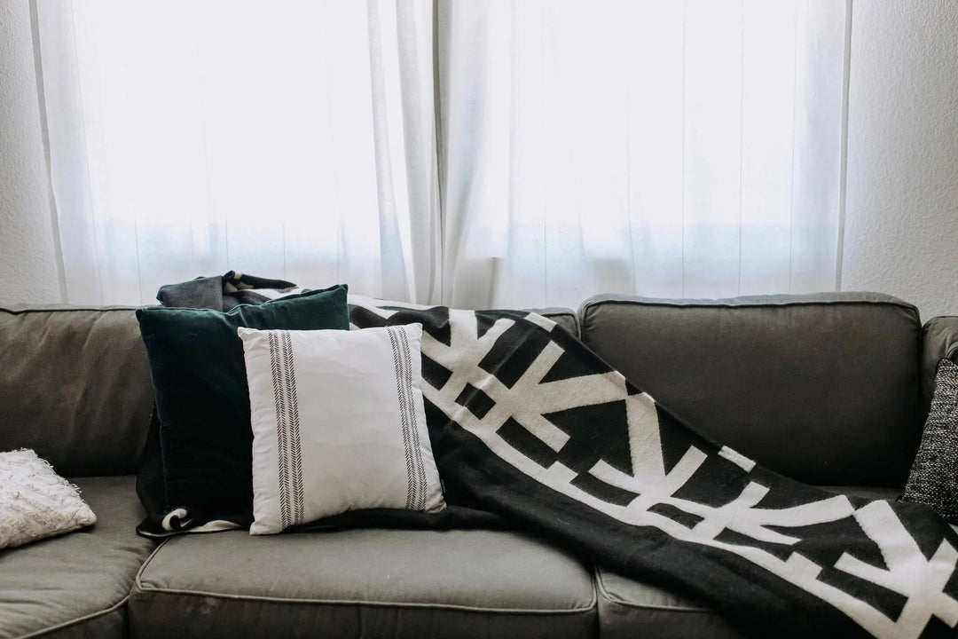 Beyond Borders Collective Destino blanket in minimalist black and cream.