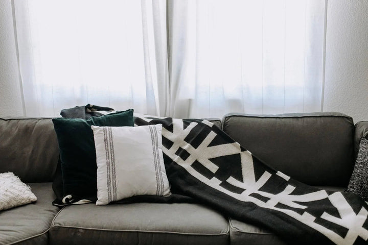Beyond Borders Collective Destino blanket in minimalist black and cream.