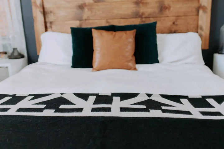 Destino Andean throw in black and cream with a bound edge.