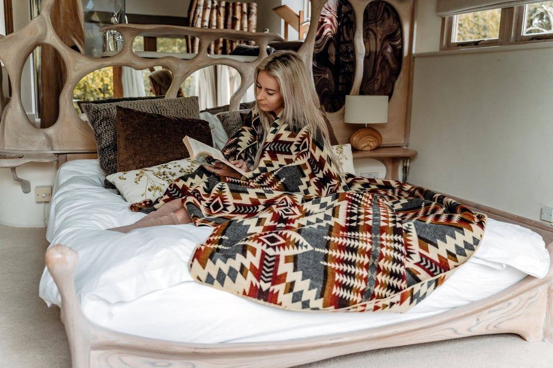Campfire Ash Andean throw showing the warm, earthy weave with tasseled fringe.