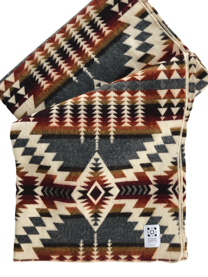Handwoven Andean fringed throw in Campfire Ash - grey, cream, rust, and mustard.