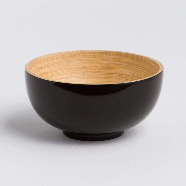 Handcrafted bamboo dining bowl with natural grain and a rounded shape.