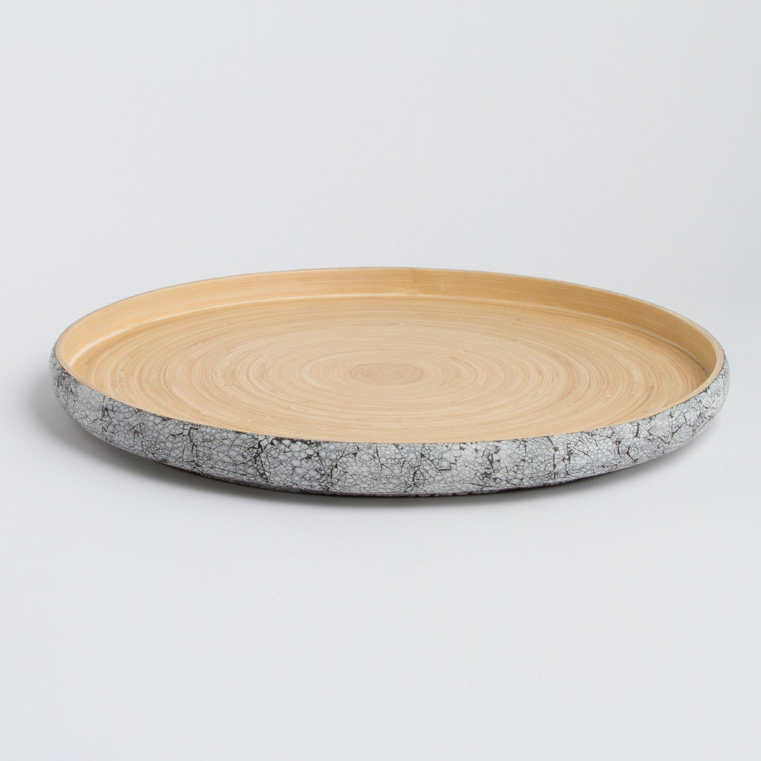 Handcrafted round bamboo tray with a natural finish for serving or decor.
