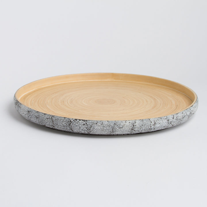 Handcrafted round bamboo tray with a natural finish for serving or decor.