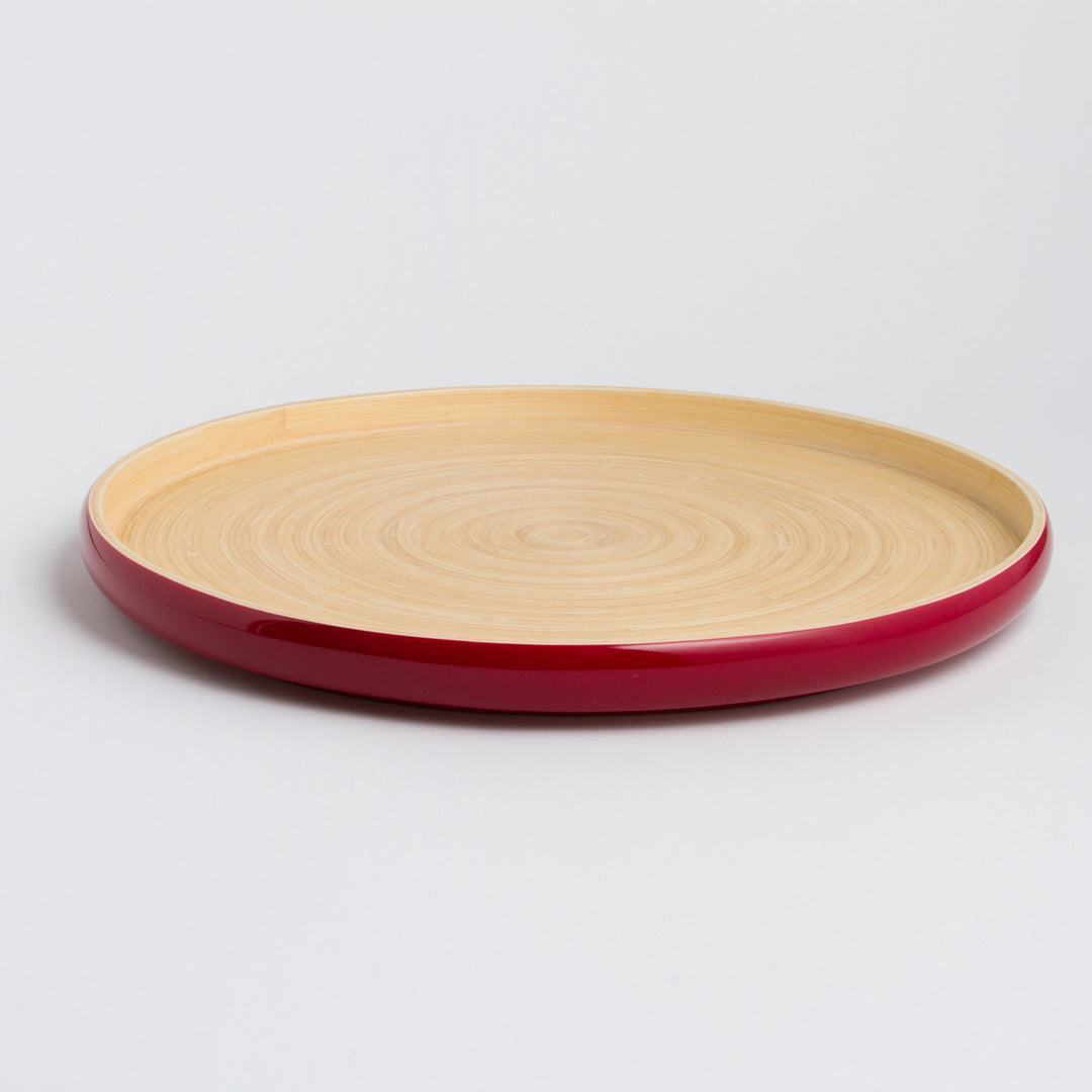 Handcrafted round bamboo tray with natural bamboo grain.