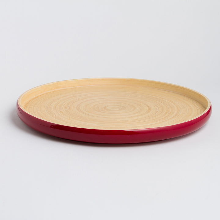 Handcrafted round bamboo tray with natural bamboo grain.