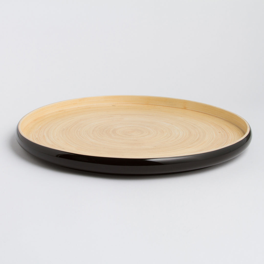 Handcrafted round bamboo tray with a natural finish for serving or decor.