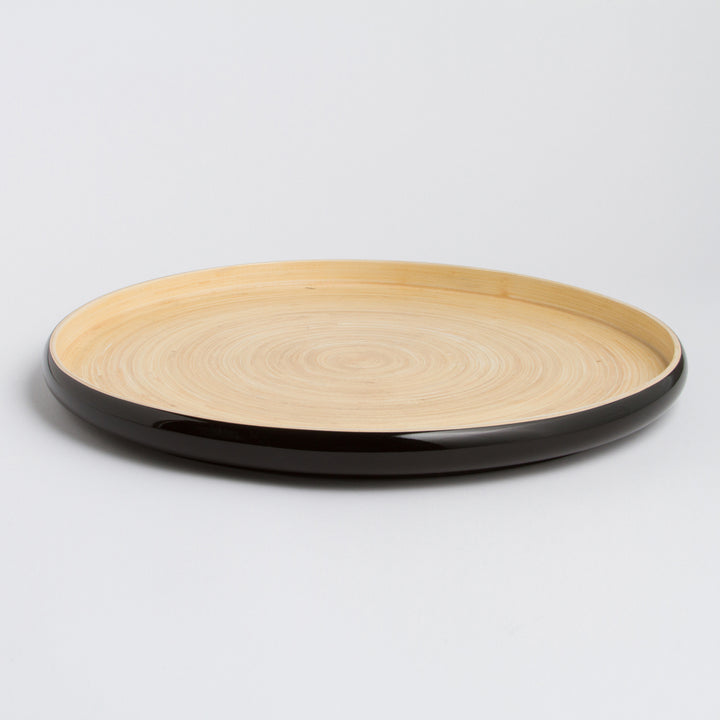 Handcrafted round bamboo tray with a natural finish for serving or decor.