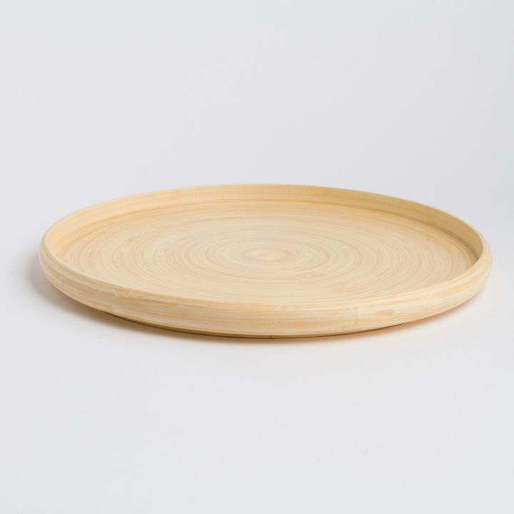 Handcrafted round bamboo tray with a smooth finish and natural texture.