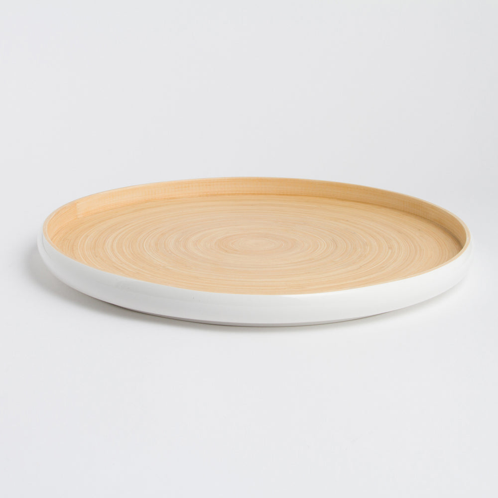 Handcrafted round bamboo tray with raised edges for serving or display.