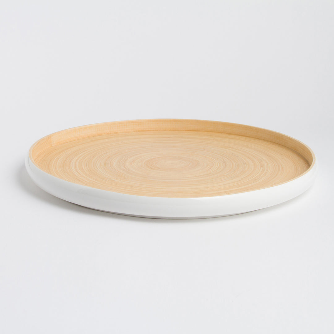 Handcrafted round bamboo tray with raised edges for serving or display.